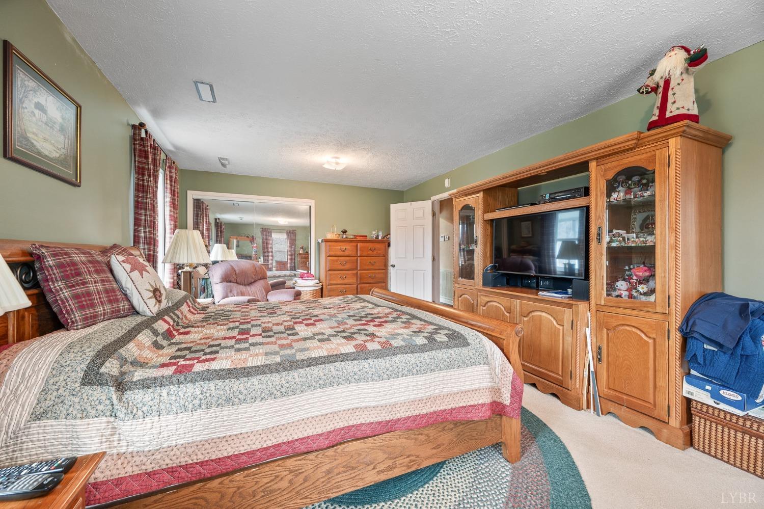1425 Kentmoor Farm Road Madison Heights, VA 24572 - Photo 32 of 47 a bedroom with bed and flat screen tv