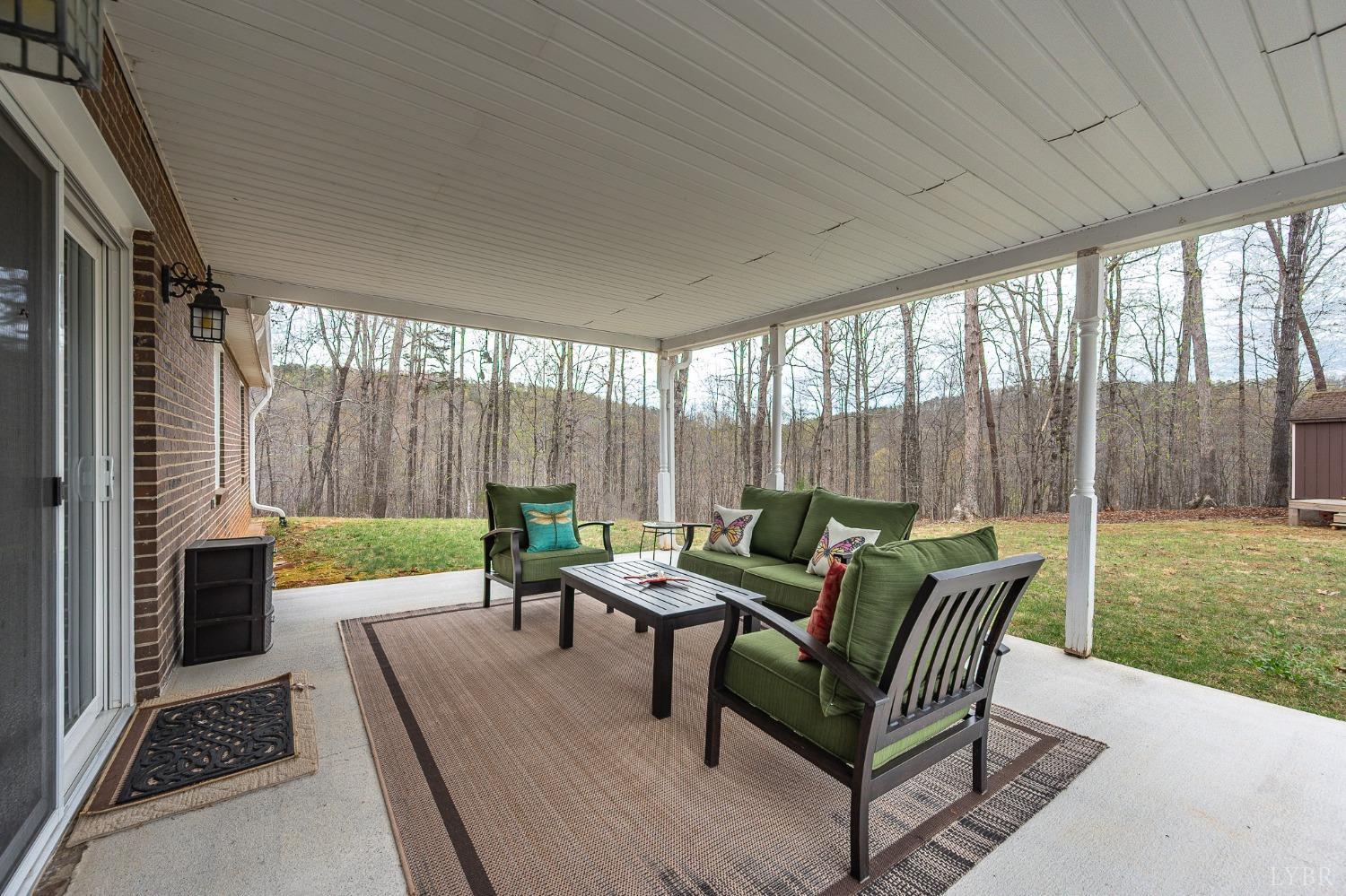 1425 Kentmoor Farm Road Madison Heights, VA 24572 - Photo 40 of 47 a outdoor space with patio the couches and a dining table with garden view