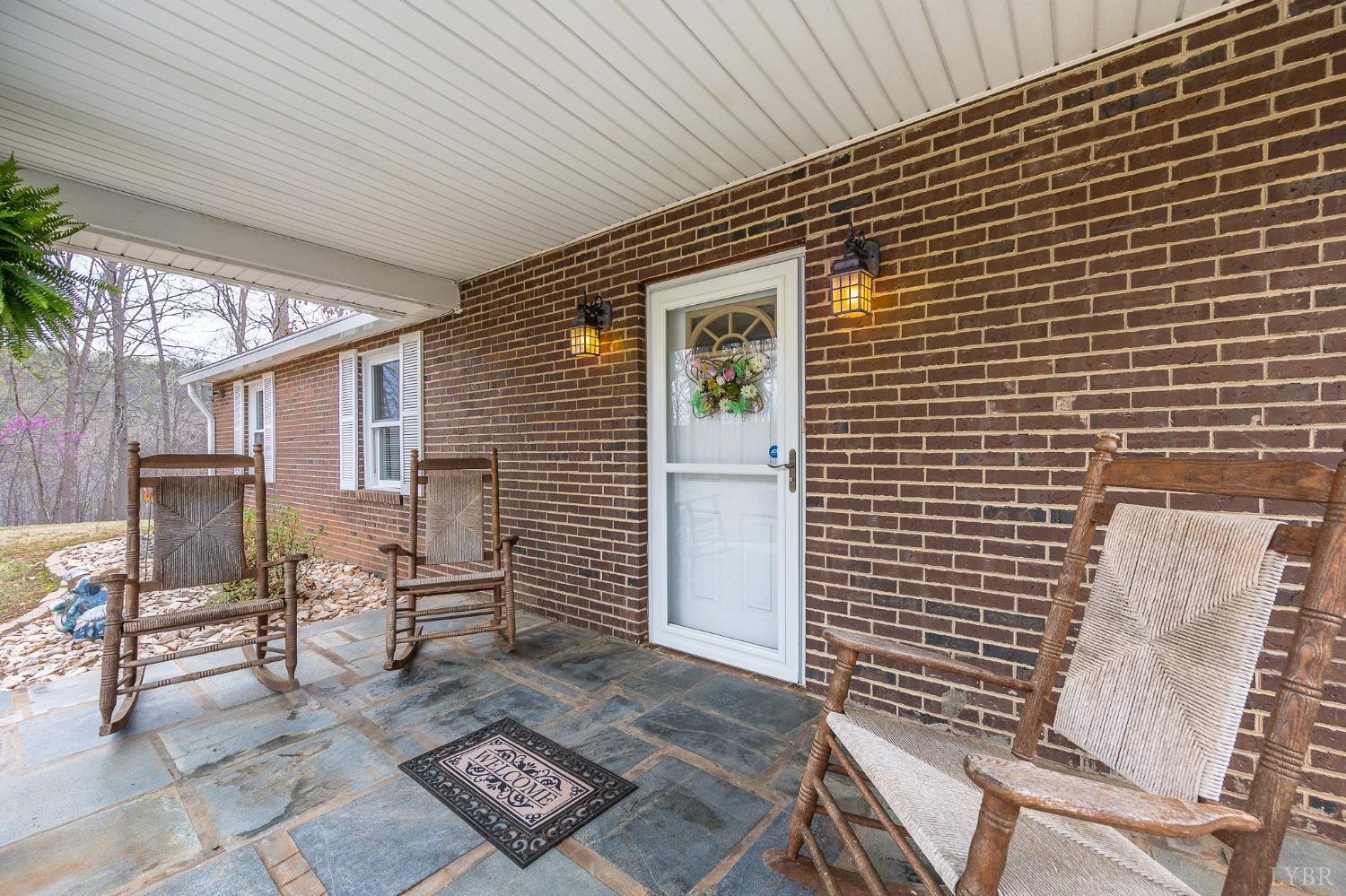 1425 Kentmoor Farm Road Madison Heights, VA 24572 - Photo 9 of 47 a view of a patio with table and chairs with wooden floor and fence