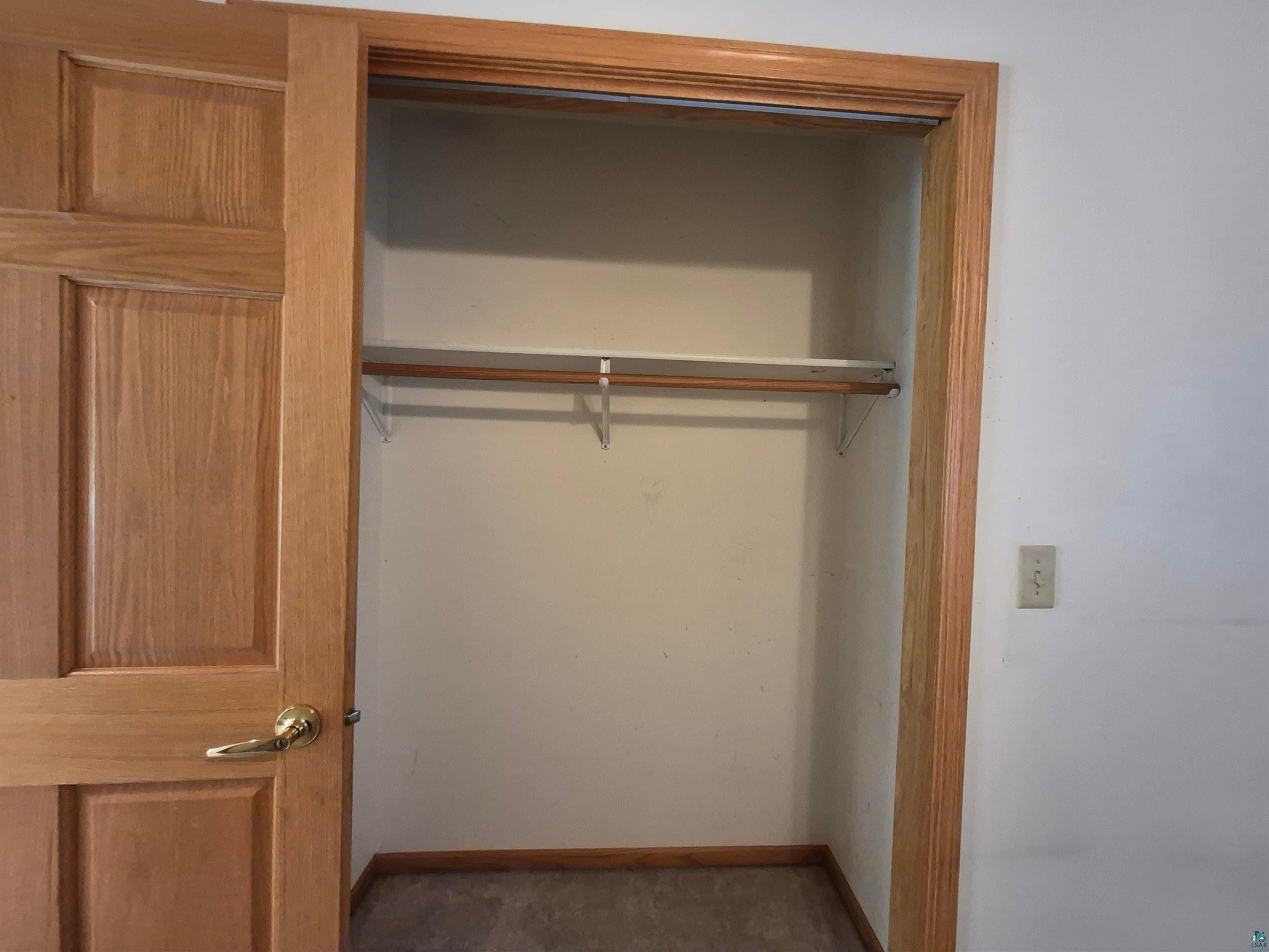 3020 East 8th Street Superior, WI 54880 - Photo 32 of 37 Built-in closet with wood-finish trim, panel door, and hanging rod