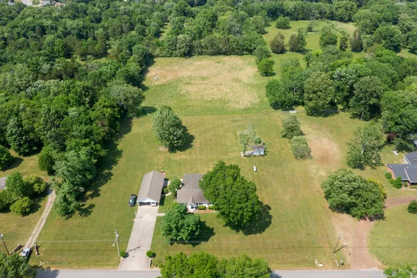 an aerial view of a houses with yard
