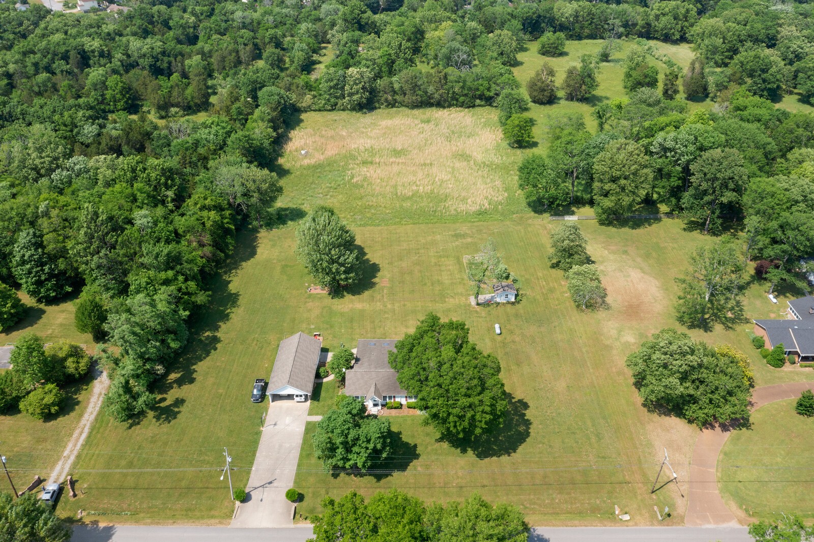 an aerial view of a houses with yard