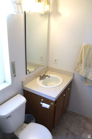 22580 Spring Creek Drive, Unit B61 Fairview, UT 84629 - Photo 31 of 39 Bathroom featuring a vanity with a laminate countertop, an integrated sink, and a wood-finish cabinet