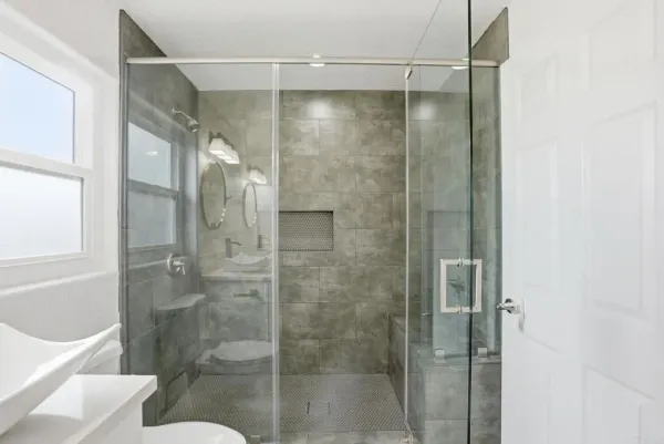 a bathroom with a glass door shower