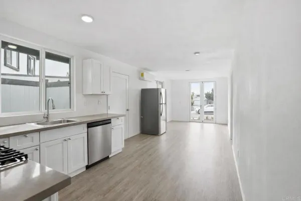 a kitchen with stainless steel appliances granite countertop a stove and a sink