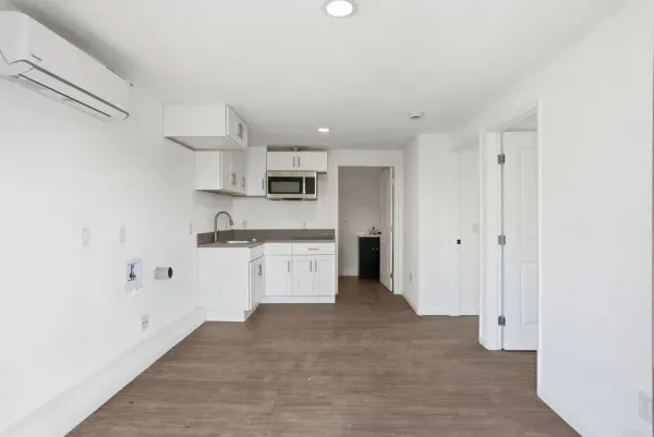 a kitchen with stainless steel appliances granite countertop a sink and a microwave