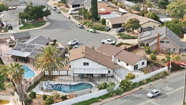 an aerial view of residential houses with outdoor space