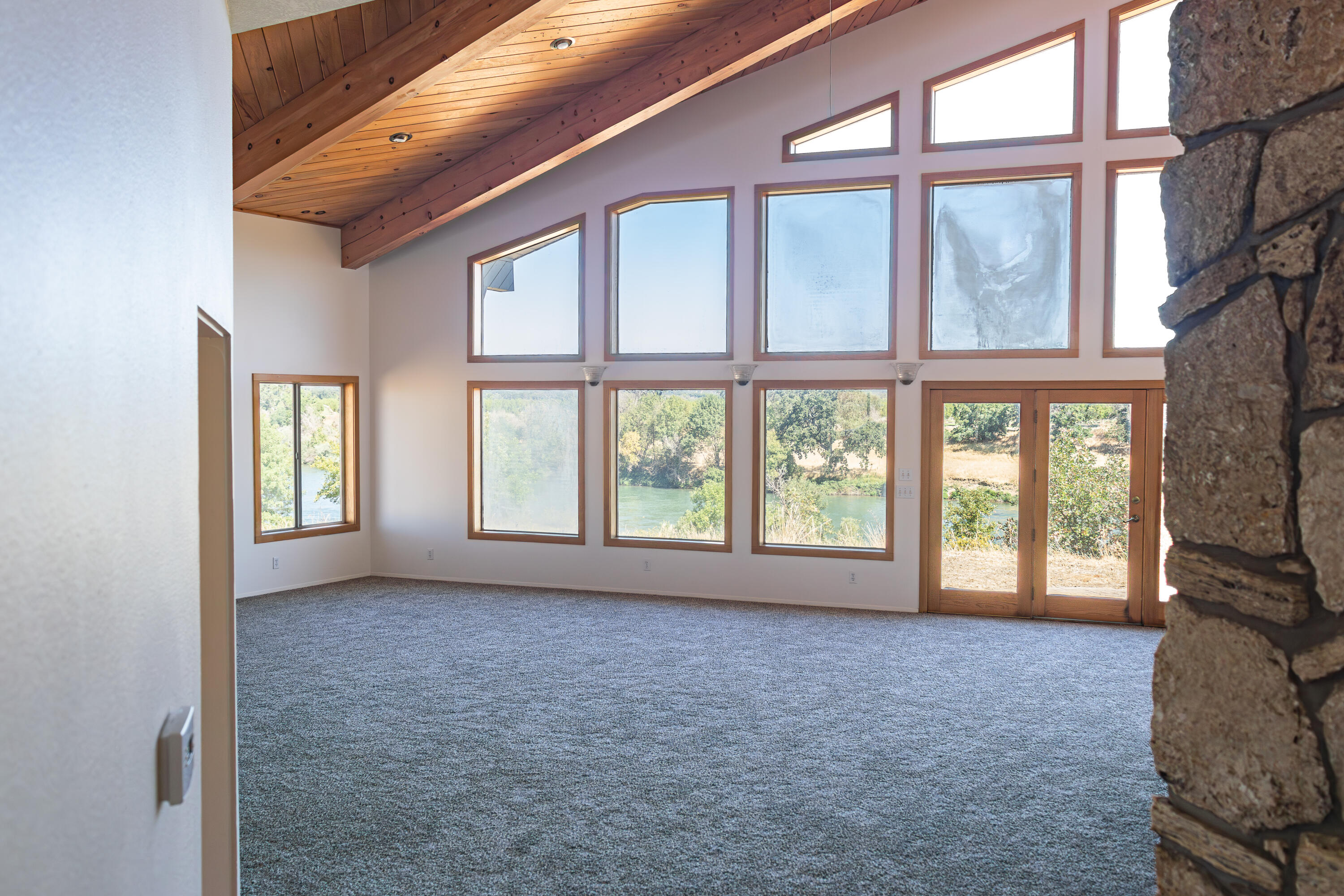 17945 Rivers Edge Drive Red Bluff, CA 96080 - Photo 17 of 25 a view of an empty room with a large window and hardwood floor