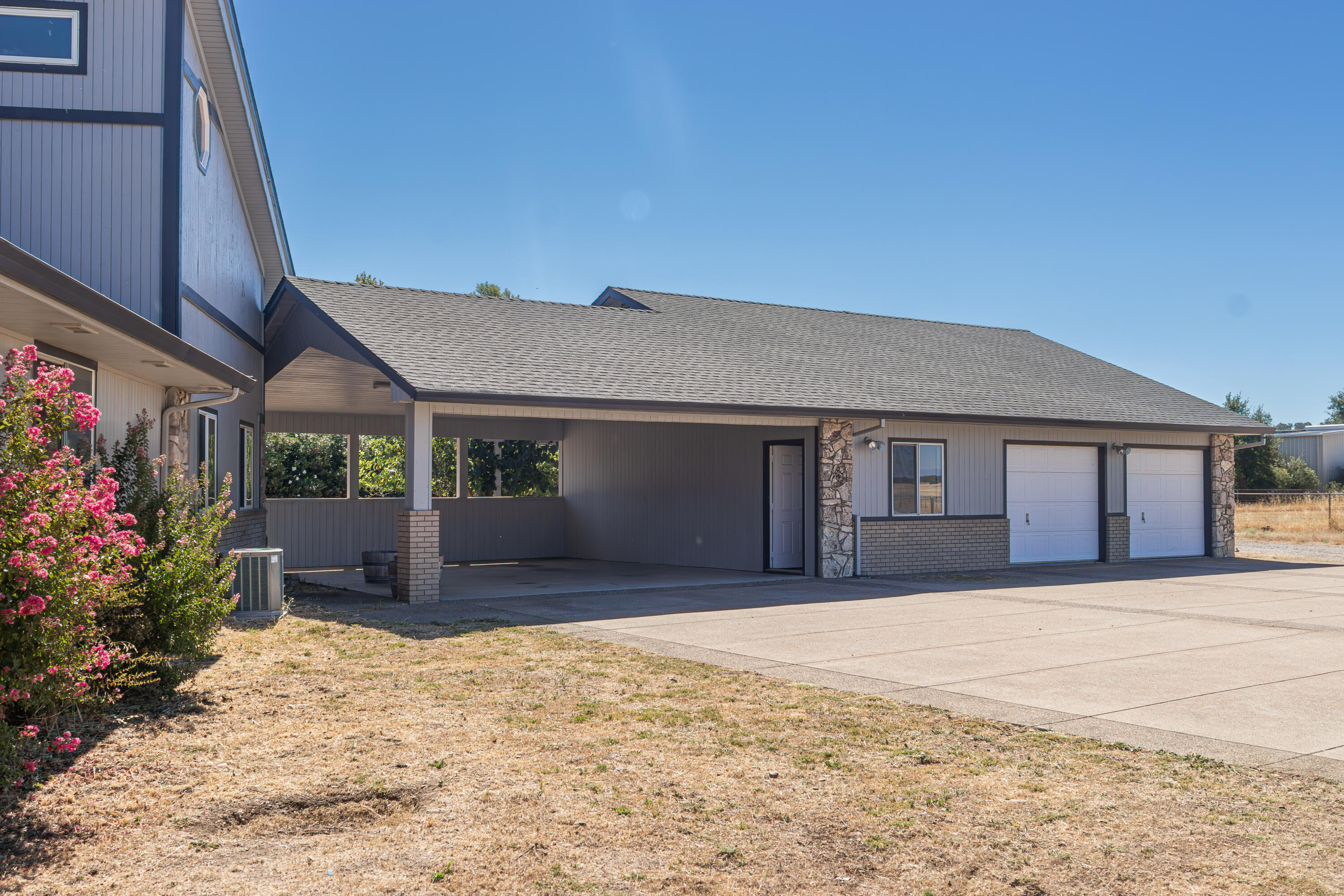 17945 Rivers Edge Drive Red Bluff, CA 96080 - Photo 6 of 25 a front view of a house with a yard and garage