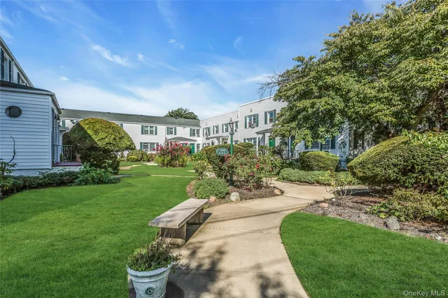 a view of a house with a backyard and a patio