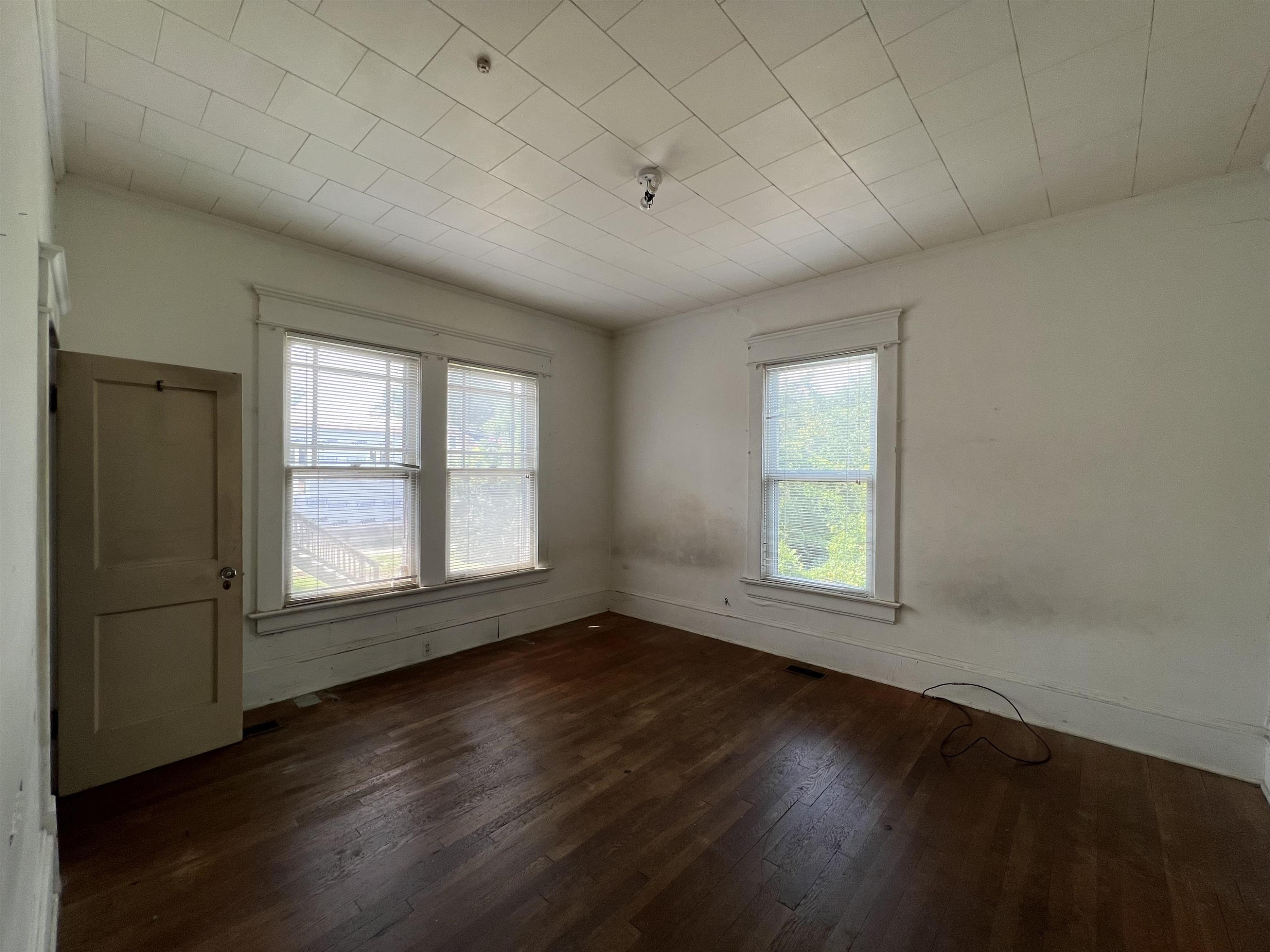 1309 Lancaster Street Durham, NC 27705 - Photo 12 of 30 an empty room with wooden floor and windows