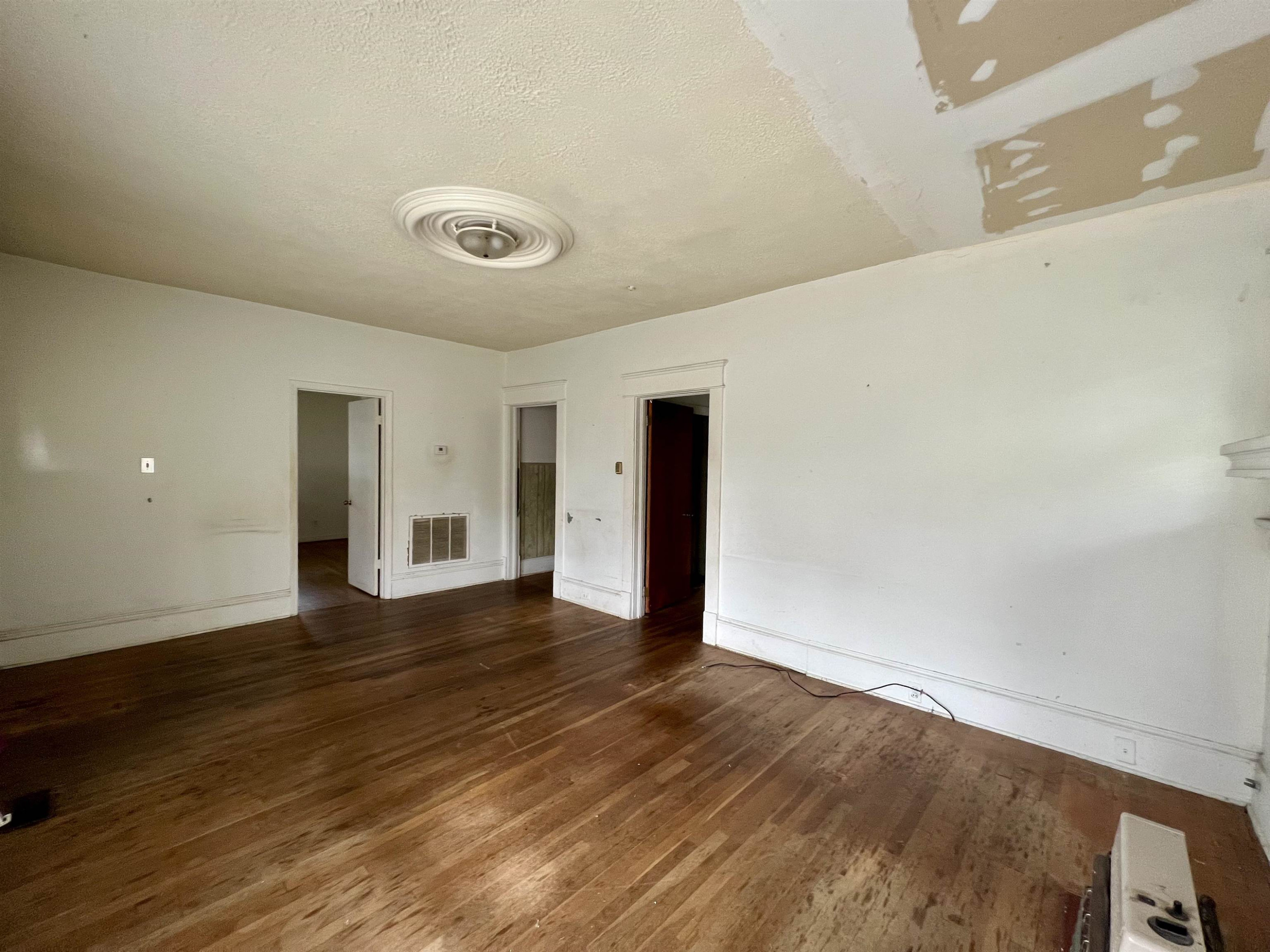1309 Lancaster Street Durham, NC 27705 - Photo 3 of 30 a view of a room with wooden floor and window