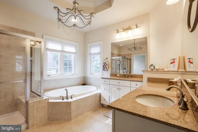 a bathroom with a granite countertop sink mirror and bathtub