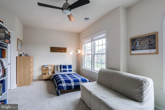 a bedroom with a large bed and a couch