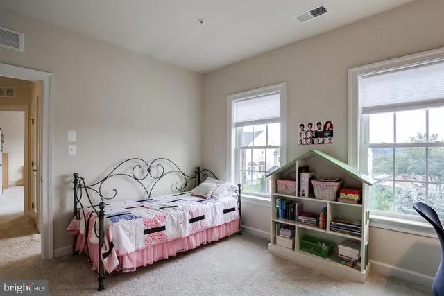 a bedroom with bed and a window
