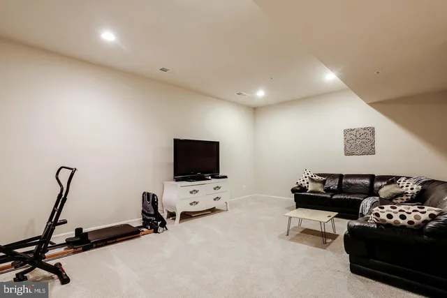 a view of a livingroom with workspace and a couch