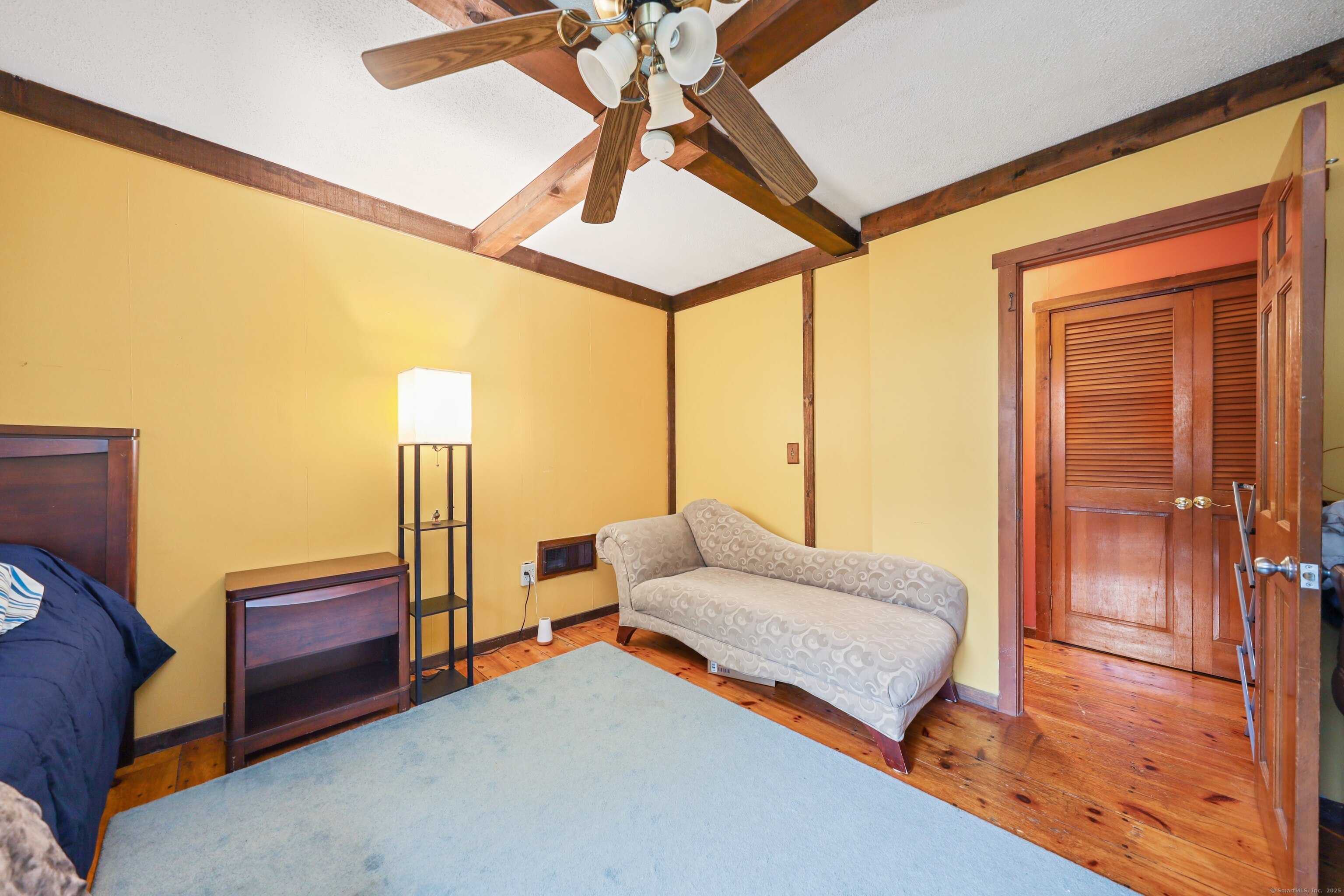 3 Rozum Circle Prospect, CT 06712 - Photo 14 of 40 a bedroom with a bed and wooden floor