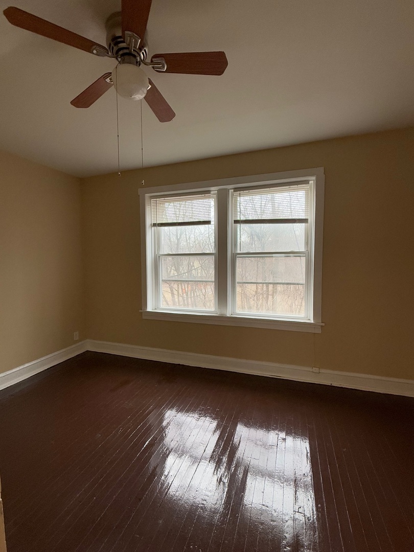 715 West 57th Street, Unit 2 Chicago, IL 60621 - Photo 11 of 12 an empty room with wooden floor fan and windows