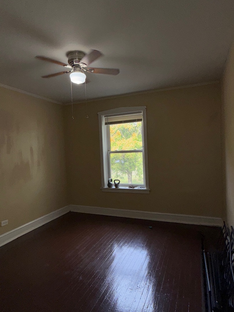 715 West 57th Street, Unit 2 Chicago, IL 60621 - Photo 3 of 12 an empty room with wooden floor and windows