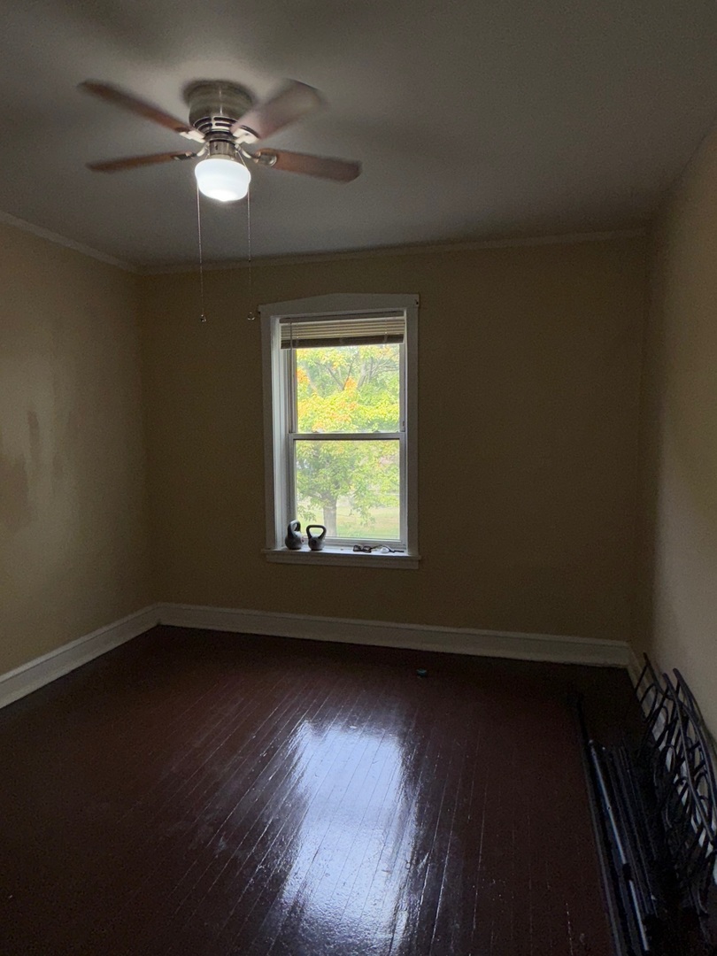 715 West 57th Street, Unit 2 Chicago, IL 60621 - Photo 4 of 12 an empty room with wooden floor and windows