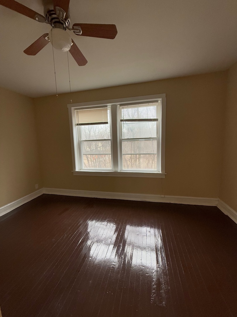715 West 57th Street, Unit 2 Chicago, IL 60621 - Photo 5 of 12 a view of empty room with wooden floor and fan
