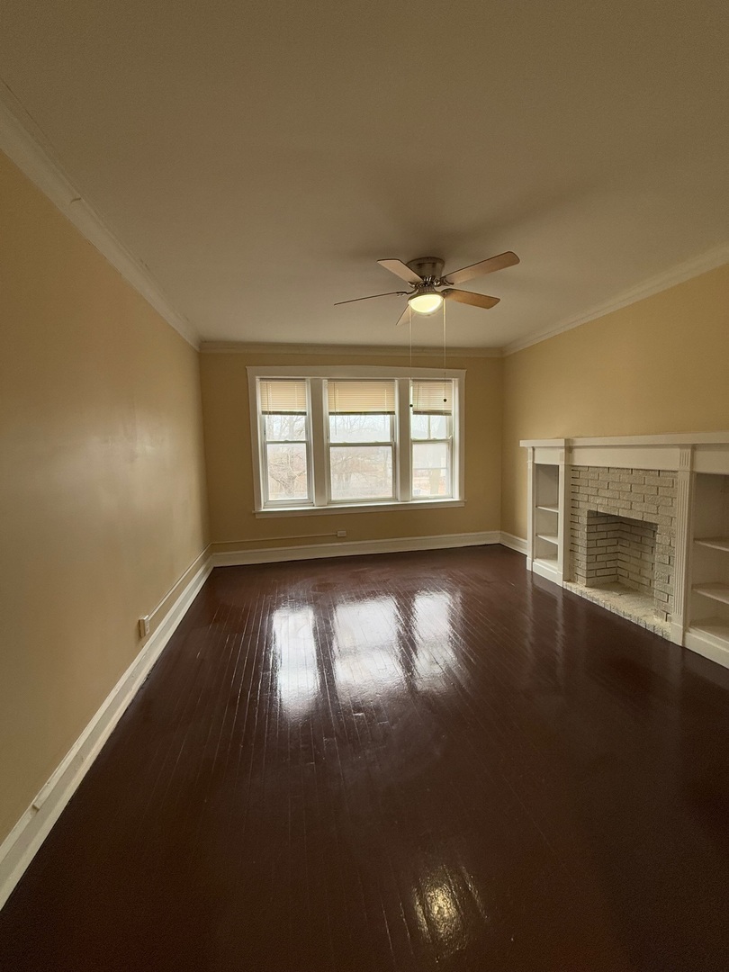 715 West 57th Street, Unit 2 Chicago, IL 60621 - Photo 7 of 12 an empty room with wooden floor and windows