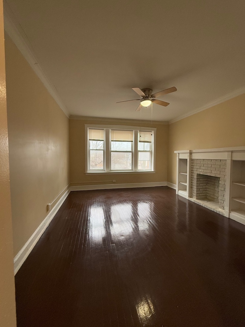 715 West 57th Street, Unit 2 Chicago, IL 60621 - Photo 8 of 12 an empty room with wooden floor and windows