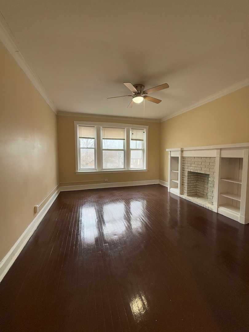 715 West 57th Street, Unit 2 Chicago, IL 60621 - Photo 9 of 12 an empty room with wooden floor and windows