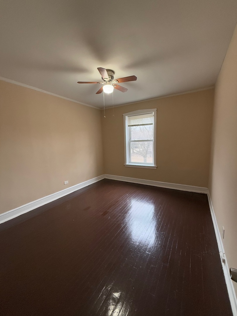 715 West 57th Street, Unit 2 Chicago, IL 60621 - Photo 10 of 12 an empty room with wooden floor and windows