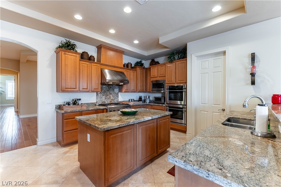 3661 Riley Ann Avenue Las Vegas, NV 89139 - Photo 15 of 42 Culinary creations come to life in this kitchen, complete with a granite island and recessed lighting.