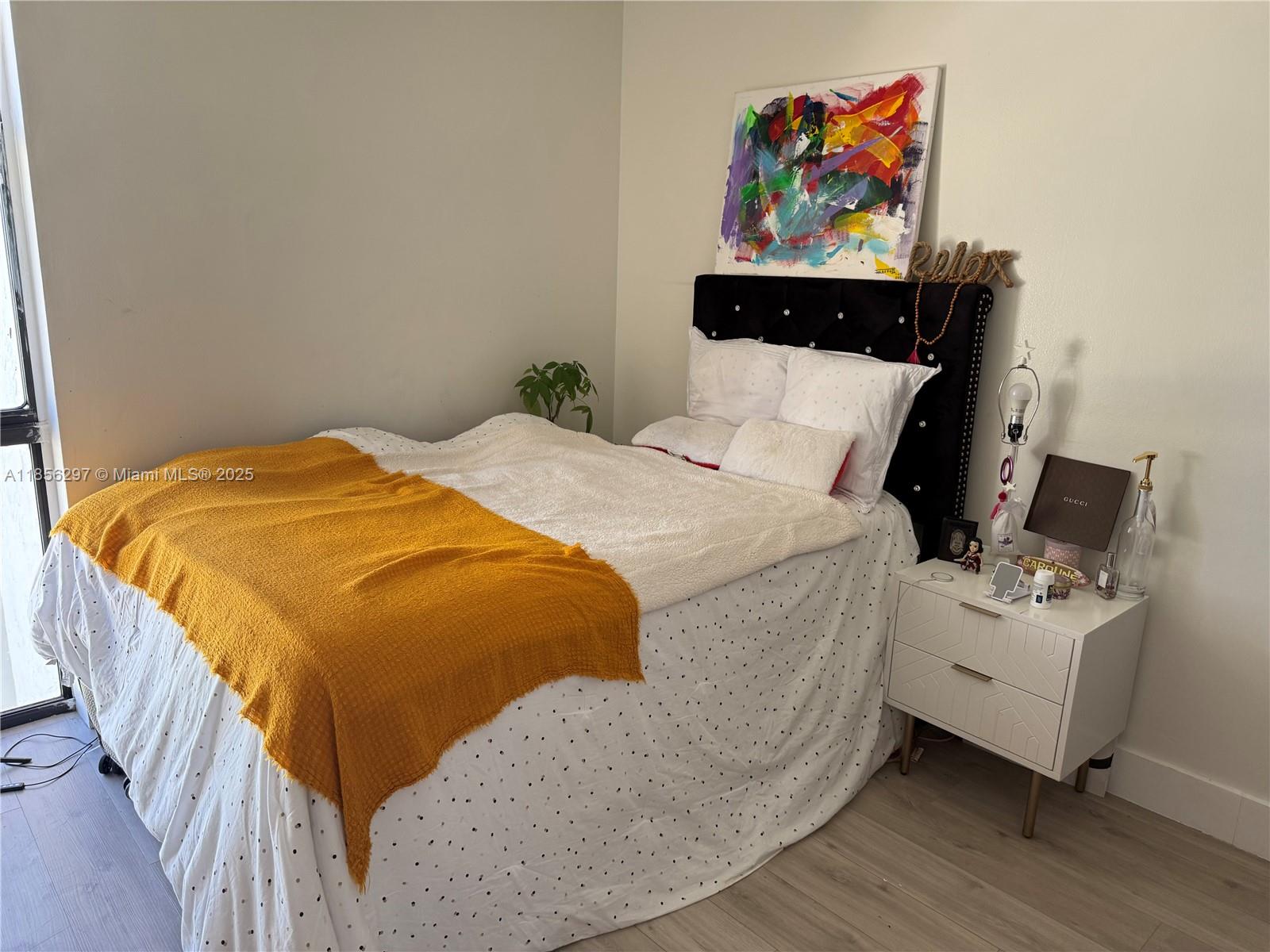 16919 North Bay Road, Unit 710 Sunny Isles Beach, FL 33160 - Photo 7 of 7 a bed sitting in a bedroom next to a lamp