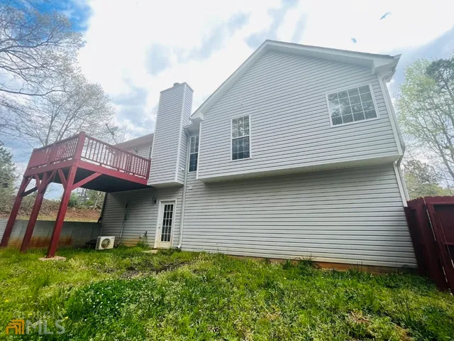 a front view of a house with plants