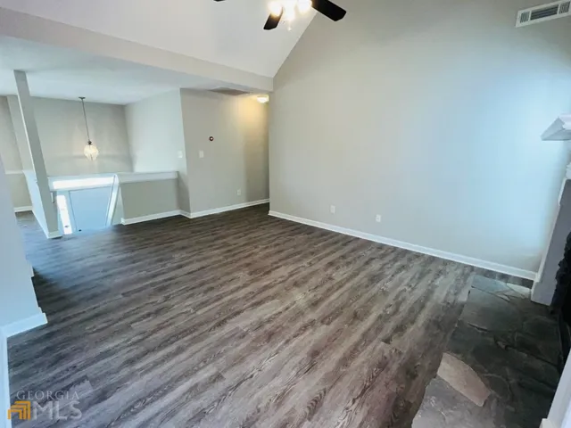a view of a room with wooden floor and a sink