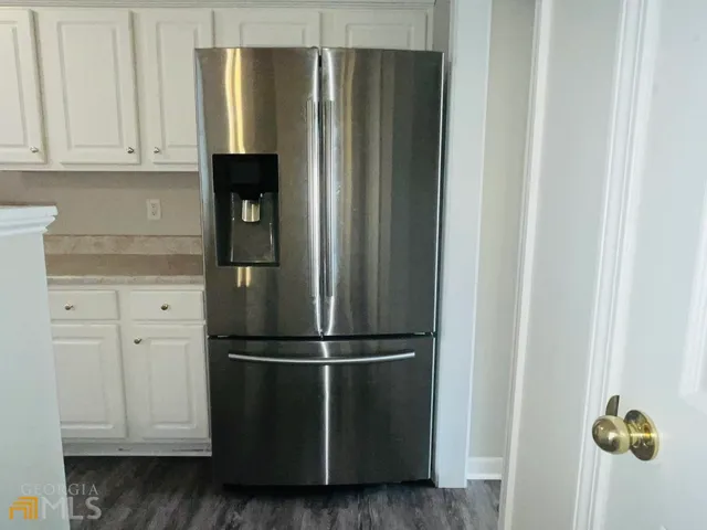 a kitchen with a refrigerator and cabinets