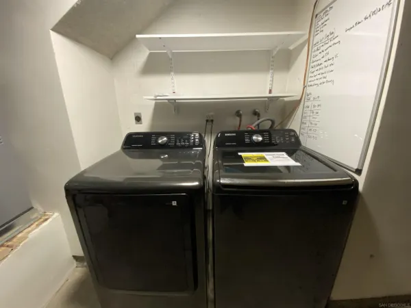an empty room with a ceiling fan and carpet