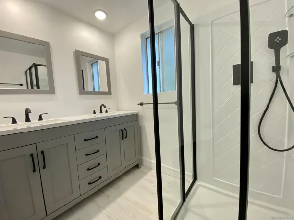 a bathroom with a sink a toilet and mirror