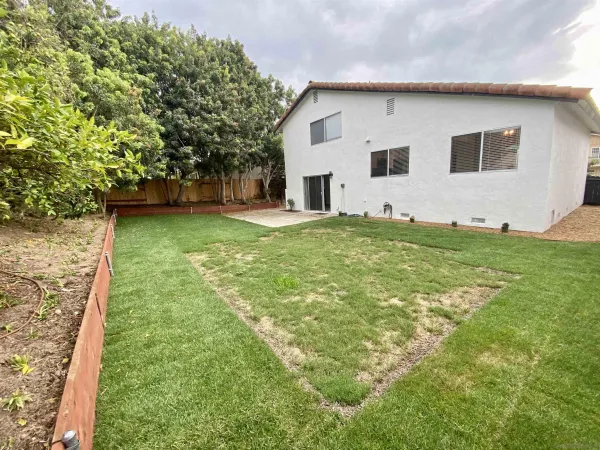a view of a house with a yard and plants