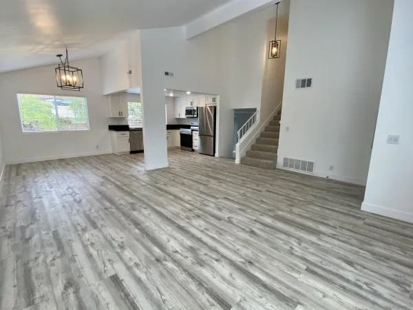 a kitchen with stainless steel appliances granite countertop a stove a sink and a refrigerator