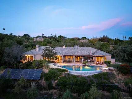 an aerial view of residential houses with outdoor space and swimming pool