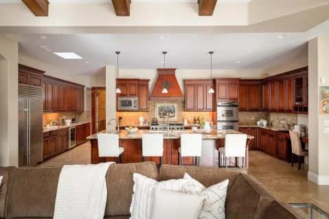 a living room with lots of furniture and kitchen view