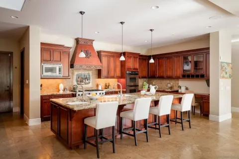 a kitchen with stainless steel appliances kitchen island granite countertop a stove and refrigerator