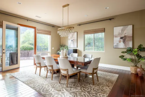 a view of a dining room with furniture wooden floor and chandelier