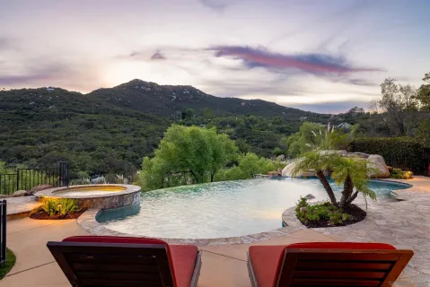 a view of a house with swimming pool and sitting area