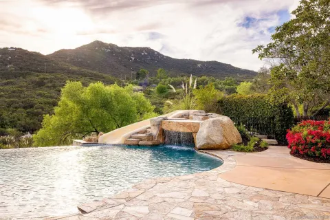 a view of yard with swimming pool and sitting area