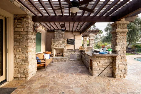 a view of a patio with couches table and chairs and potted plants