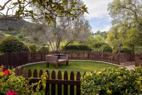 a backyard of a house with table and chairs