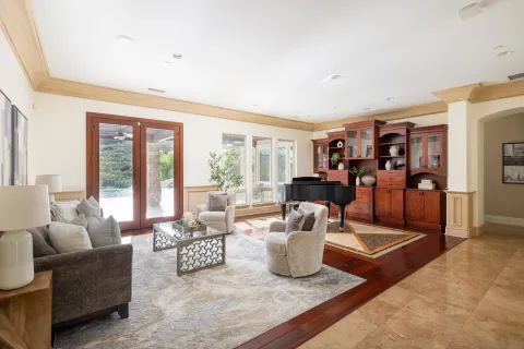 a living room with furniture and large windows