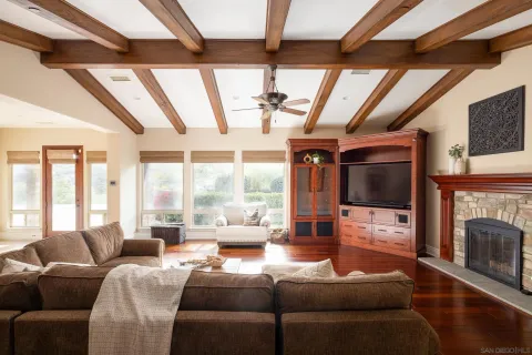 a living room with furniture a fireplace and a flat screen tv