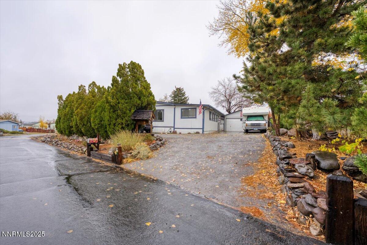 a view of a house with a tree and a yard