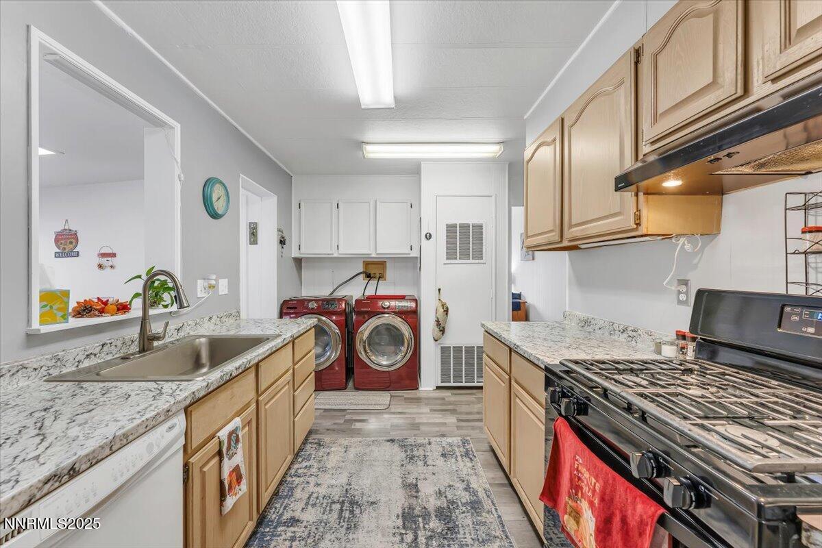 485 Capricorn Circle Reno, NV 89521 - Photo 11 of 31 a kitchen with kitchen island granite countertop a stove and a sink